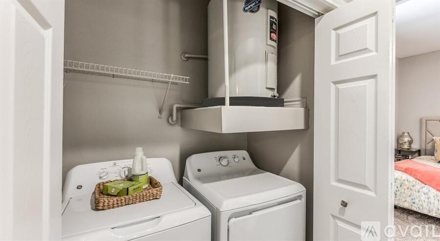 A small laundry room with a washer and dryer.