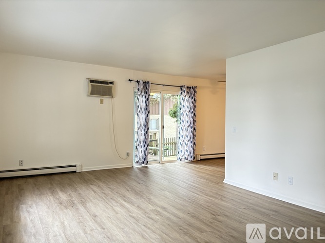 A room with a window and a sliding glass door.