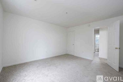 A room with two doors and two windows.