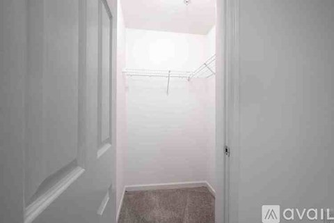 A room with a window and carpeted floor.