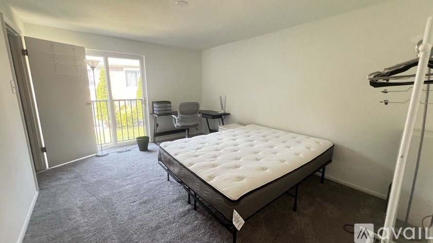 A bedroom with a large bed and a small table.