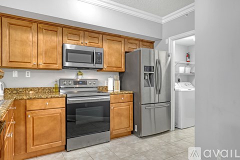 A kitchen with wooden cabinets and stainless steel appliances.