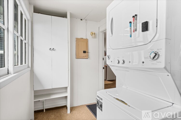 A white oven with a control panel on the front is in a kitchen.