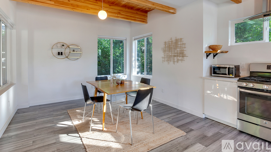 A dining area with a table and chairs is shown.