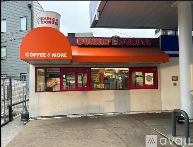 A Dunkin' Donuts storefront with a red awning and a sign that reads "Coffee & More."