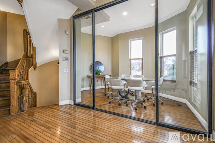 A room with a glass door leading to a balcony.