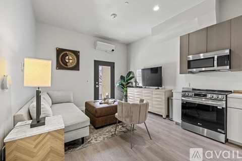 A modern kitchen with a dining table and chairs.
