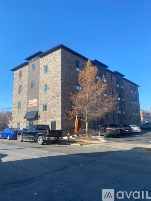 A tall building with a parking lot in front of it.