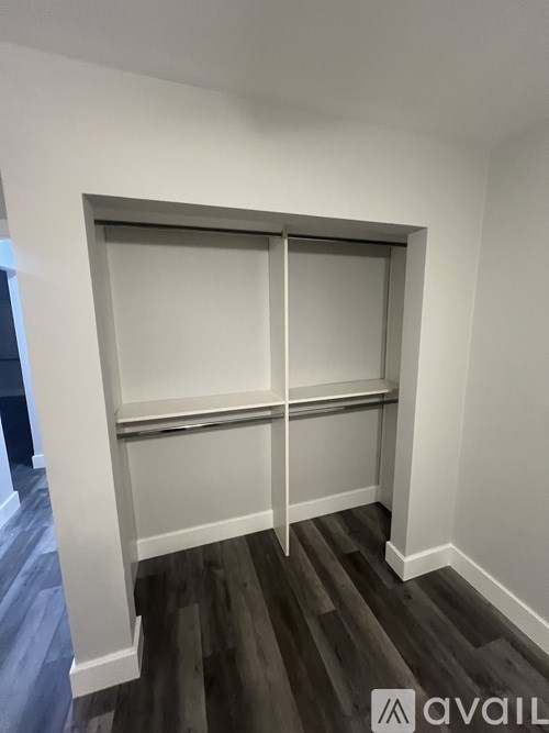 A white closet with a sliding door and shelves.