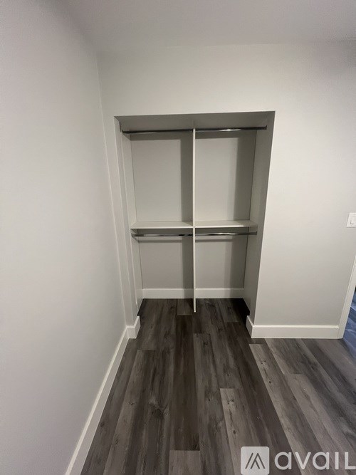 A room with a sliding door and wooden flooring.