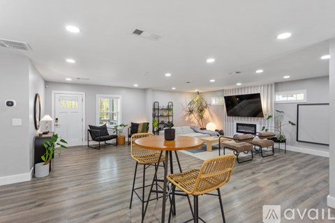 A modern living room with a wooden table and chairs.