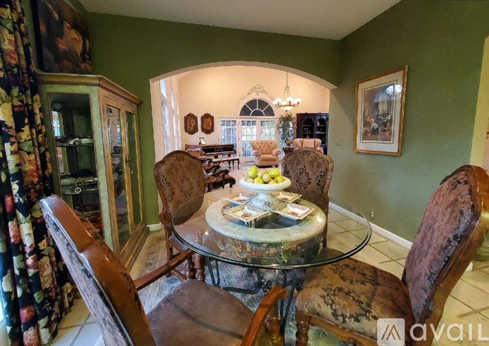 A dining room with a glass table and chairs.
