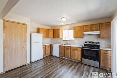 A kitchen with wooden cabinets and a white refrigerator.