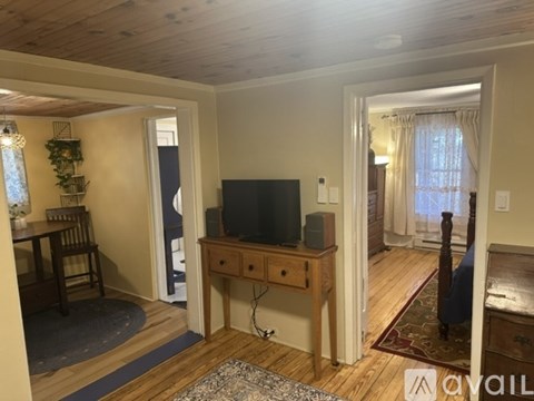 A living room with a television and a chair.