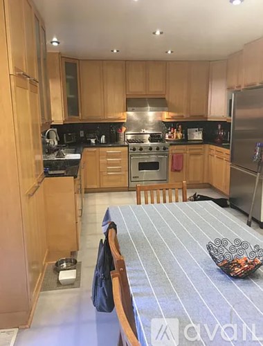 A kitchen with wooden cabinets and a stove top oven.
