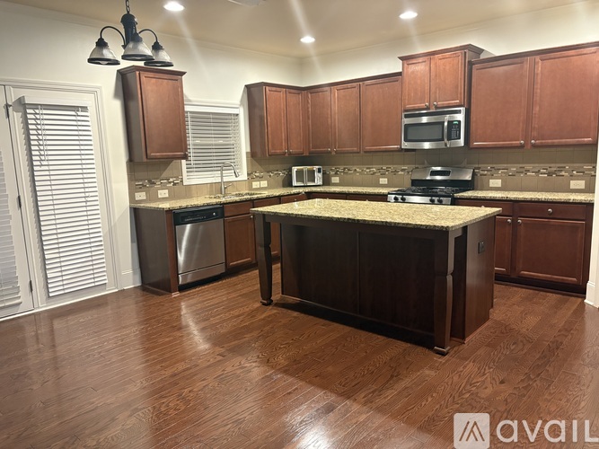 A kitchen with wooden cabinets and a granite countertop.