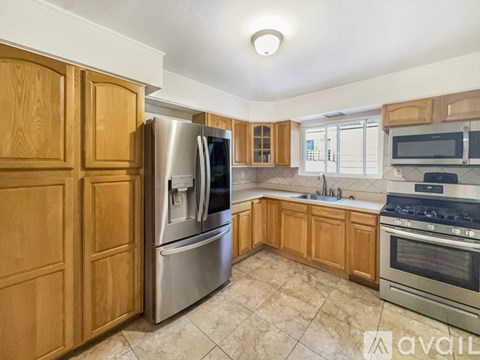 A kitchen with wooden cabinets and stainless steel appliances.