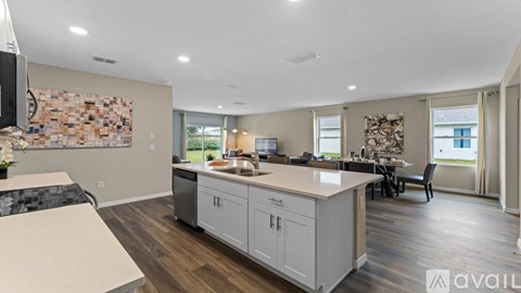 A kitchen with a counter and a wall with a mosaic tile design.