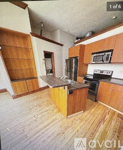 A kitchen with wooden cabinets and a black stove top oven.
