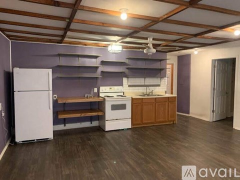 A kitchen with a white refrigerator, a white oven, and a white sink.