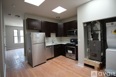 A kitchen with a stainless steel refrigerator and a stove top oven.
