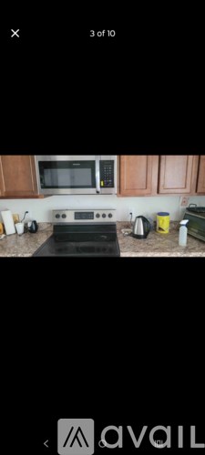 A kitchen with wooden cabinets and a black countertop.