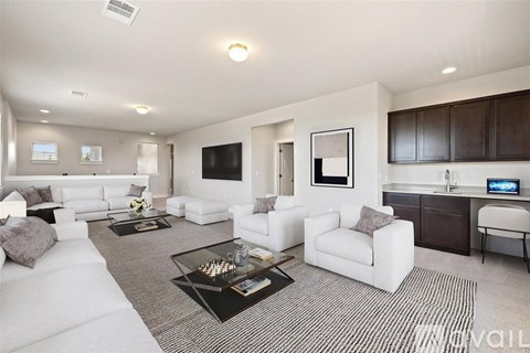 A modern living room with a white sofa set and a black coffee table.