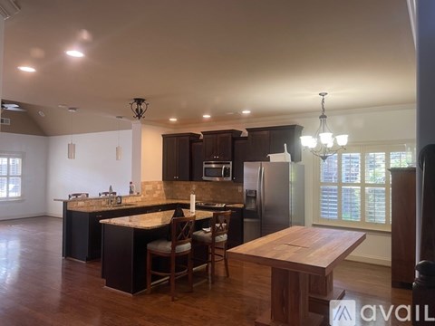 A kitchen with a table and chairs in the middle of the room.