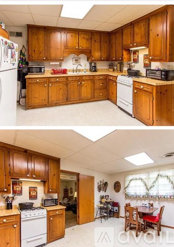 A kitchen with wooden cabinets and a white stove top oven.