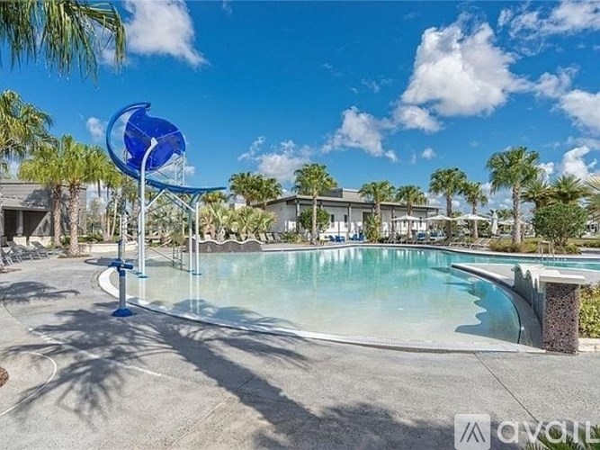 A pool with a blue sculpture in the foreground and a building in the background.