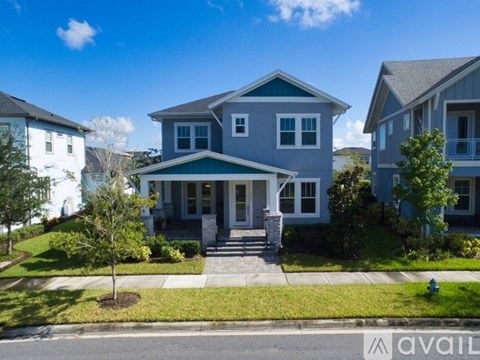 A house with a blue front yard is for sale.