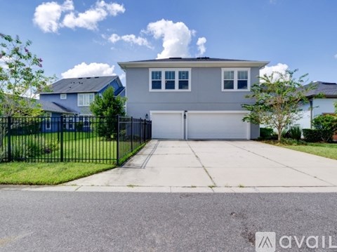 A two-story house with a garage is for sale.
