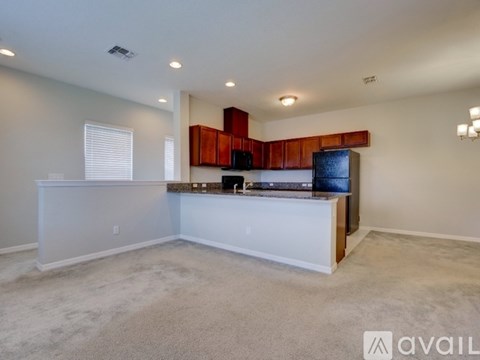 A living room with a white counter and a flat screen TV.