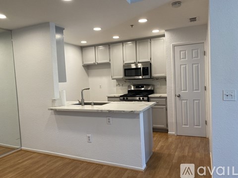 A kitchen with white cabinets and a white island.