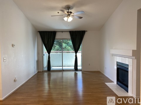 A spacious living room with a fireplace and sliding glass doors.
