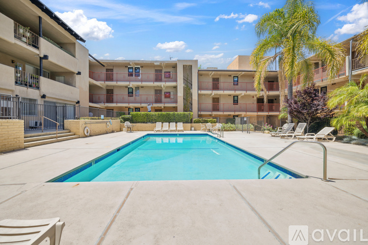 A swimming pool in front of apartment buildings.