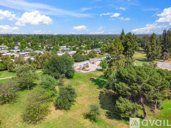 A bird's eye view of a park with a playground and trees.