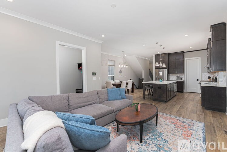 A living room with a grey couch and a coffee table.