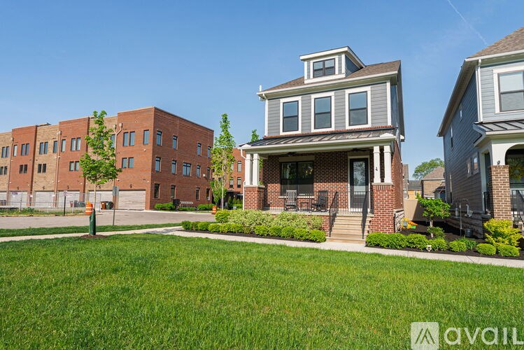 A house with a green lawn in front of it.