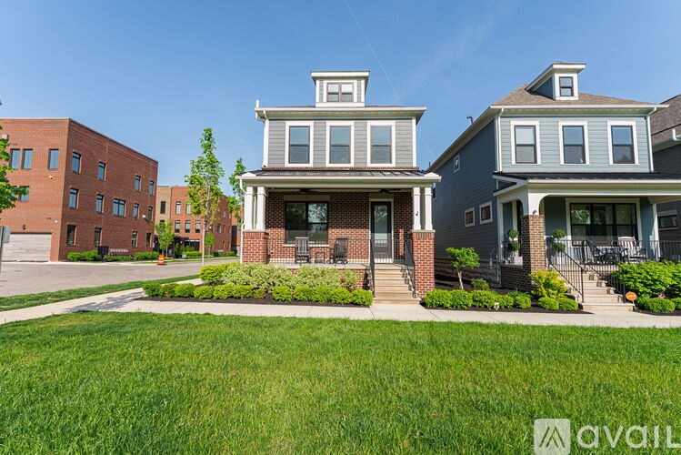 A house with a front yard and a garage is available for rent.
