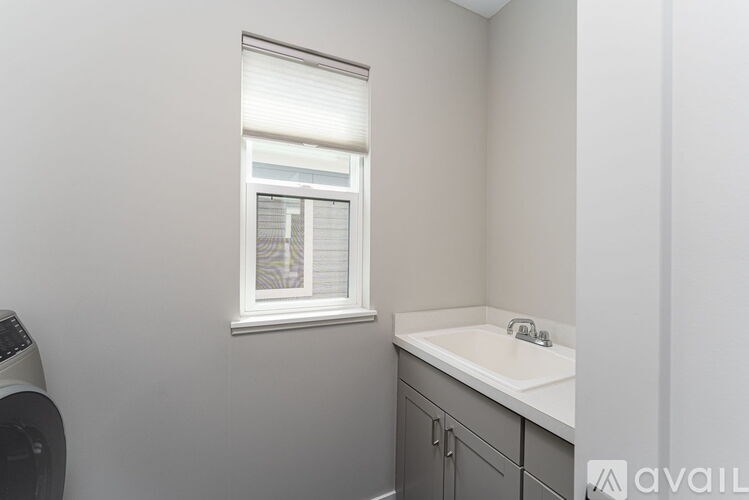 A bathroom with a window and a sink.