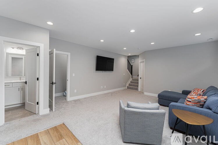A living room with a grey couch and a wooden coffee table.