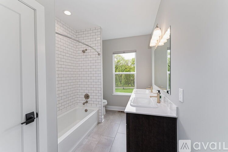 A bathroom with a white tub and sink.