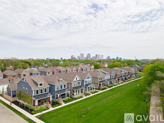 A row of houses with a city skyline in the background.