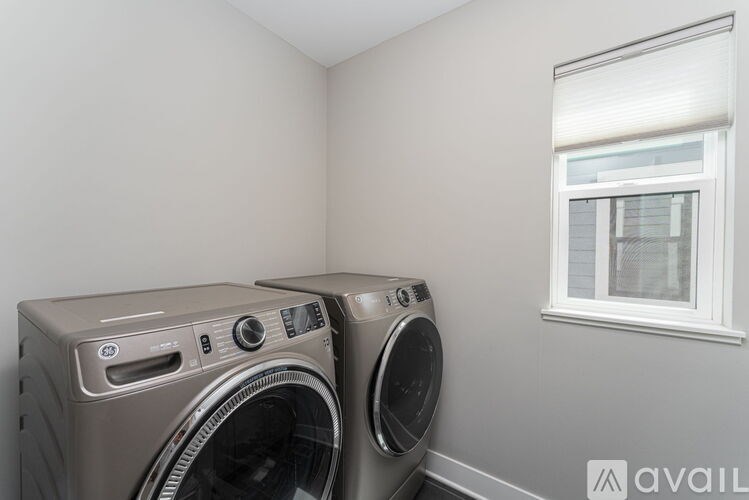 Two front load washing machines in a laundry room.
