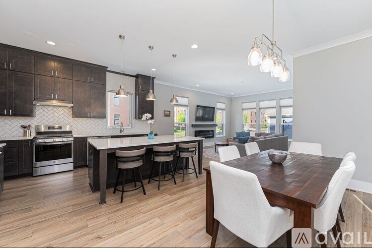 A modern kitchen with a dining table and chairs.