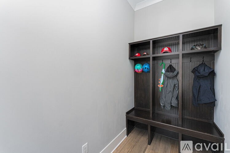 A wooden bench with a coat hanging on it.