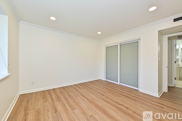 A kitchen with white cabinets and a checkered floor.