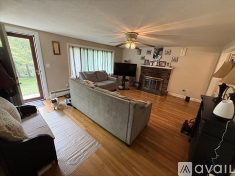 A living room with a grey couch and a wooden floor.