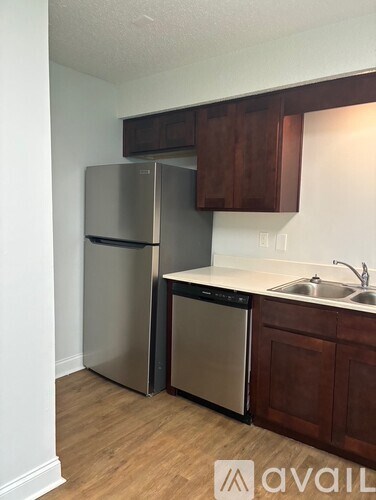 A kitchen with a stainless steel refrigerator and a sink.
